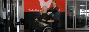 Strength & Conditioning Coach with athlete in a wheelchair