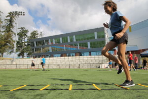Girl moving through an agility ladder