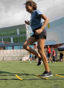 Girl moving through agility ladders